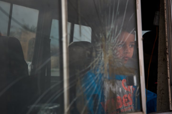 A boy who fled with his family following Israeli strikes in southern Lebanon sits inside the van they are using as shelter in Sidon, Lebanon, Thursday, April 2, 2026.