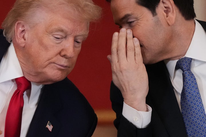 President Donald Trump speaks with Secretary of State Marco Rubio during a roundtable discussion on college sports in the East Room of the White House, Friday, March 6, 2026, in Washington. 