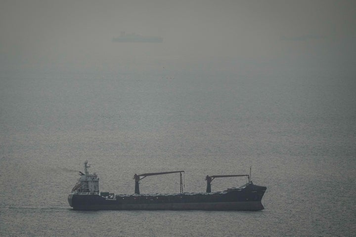 A cargo ship carrying vehicles sails through the Arabian Gulf toward the Strait of Hormuz in the United Arab Emirates, Sunday, March 22, 2026. (AP Photo)