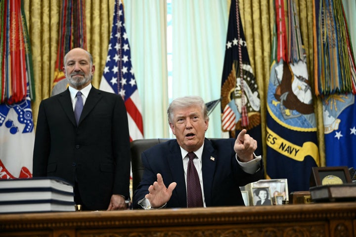 US President Donald Trump (R) speaks as Commerce Secretary Howard Lutnick (L) looks on after signing an executive order in the Oval Office of the White House in Washington, DC, on March 31, 2026.
