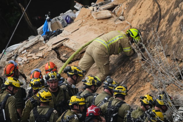 Israeli rescue teams search for missing people amid the rubble of a residential building a day after it was struck by an Iranian missile in Haifa, Israel, Monday, April 6, 2026.