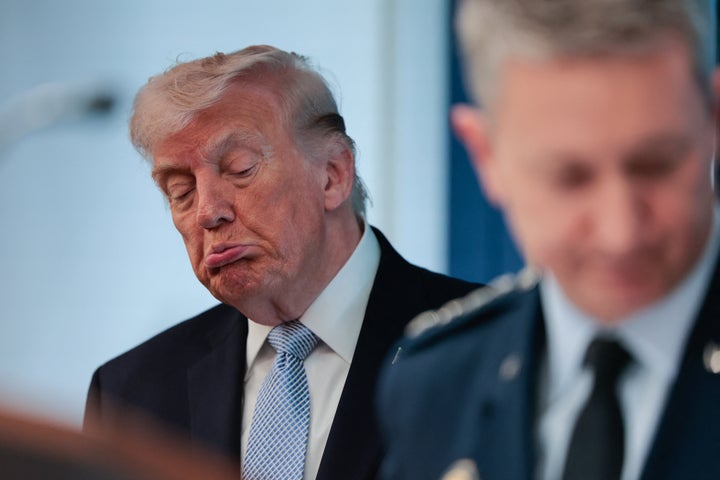 President Donald Trump (left) looks on as Chairman of the Joint Chiefs of Staff General Dan Caine (right) speaks about the conflict in Iran in the White House on April 6.