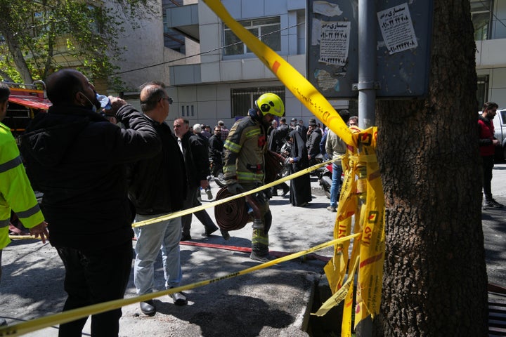 A first responder leaves the site of a strike that, according to a security official at the scene, destroyed half of the Khorasaniha Synagogue and nearby residential buildings in Tehran, Iran, on April 7, 2026.