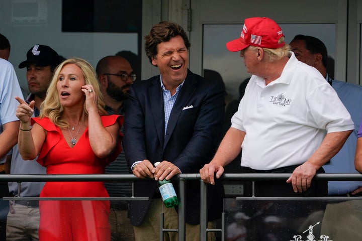 President Trump is seen with then-Rep. Marjorie Taylor Greene and Tucker Carlson at the 2022 Bedminster Invitational LIV Golf tournament in New Jersey.