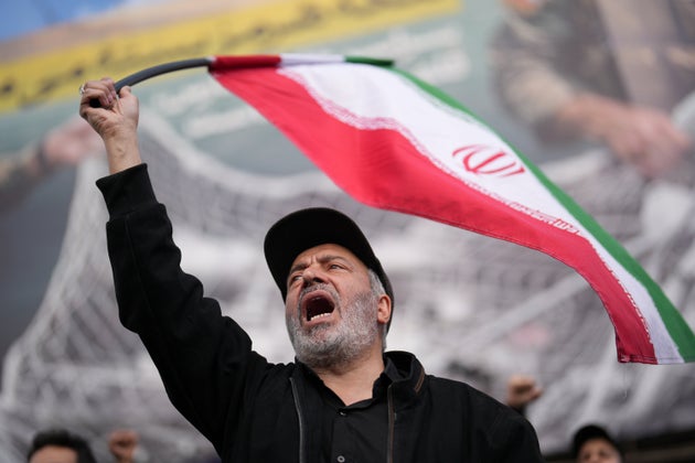 A government supporter chants slogans during a gathering after the announcement of a two-week ceasefire with the United States and Israel in Tehran.