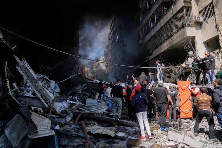 First responders search at the site of an Israeli airstrike that struck an apartment building in Beirut, Lebanon, Wednesday, April 8, 2026. (AP Photo/Bilal Hussein)