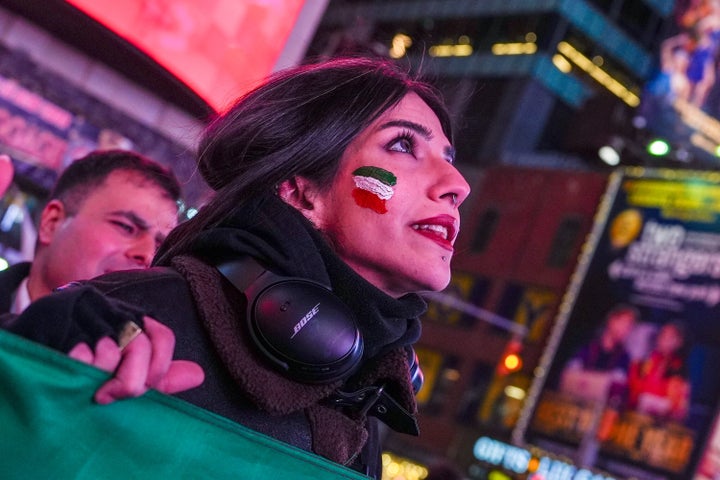 A woman with Iranian flag face paint looks up during a "Freedom for Iran" protest in support of the Iranian people in New York on March 2, 2026.