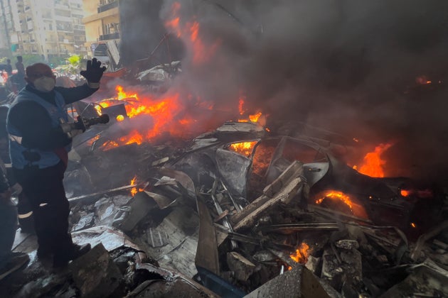 A rescue worker extinguishes burning cars at the site of an Israeli airstrike in central Beirut, Lebanon, Wednesday, April 8, 2026. 
