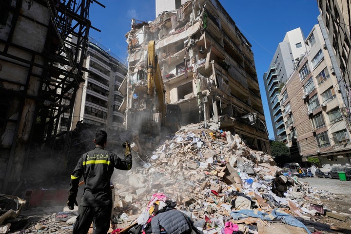 Lebanese civil defense worker gestures to an excavator as they search for victims in the rubble at the site of a building destroyed in an Israeli airstrike a day earlier in central Beirut, Lebanon, Thursday, April 9, 2026. (AP Photo/Hussein Malla)