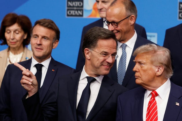 President Donald Trump, right, speaks with NATO Secretary General Mark Rutte during a group photo of NATO heads of state and government at the NATO summit in The Hague, Netherlands, Wednesday, June 25, 2025.