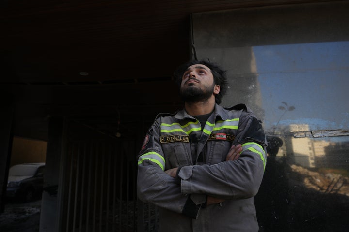 A Lebanese civil defense worker looks upward near the site of a building destroyed in an Israeli airstrike a day earlier in central Beirut, Lebanon, Thursday, April 9, 2026. (AP Photo/Hassan Ammar)