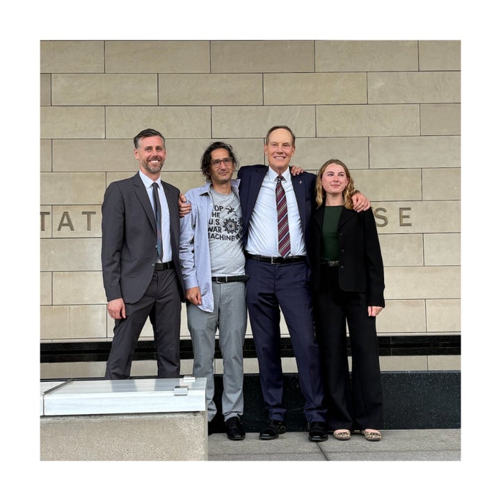 Jonathan Caravello with his legal team after a jury acquitted him of federal assault charges.