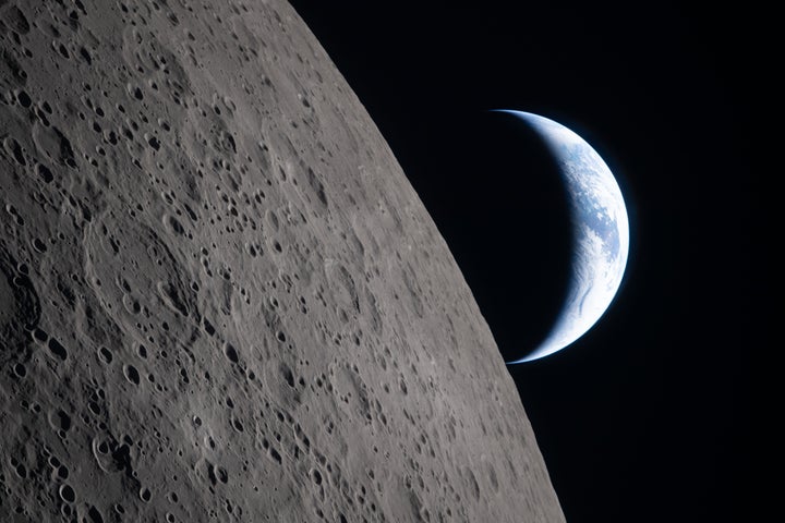 In this image provided by NASA, the Artemis II crew captured this view as the Earth sets behind the Moon during a lunar flyby on April 6, 2026.