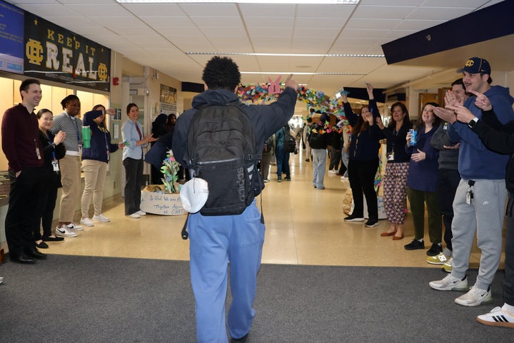 Columbia Heights High School staff members line the hallway entry to welcome back students and greet them as they enter the building.