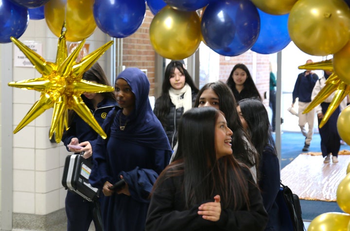 Middle school students at Columbia Academy, part of Columbia Heights Public Schools, walk through a blue-and-gold balloon arch as part of their welcome back celebration.