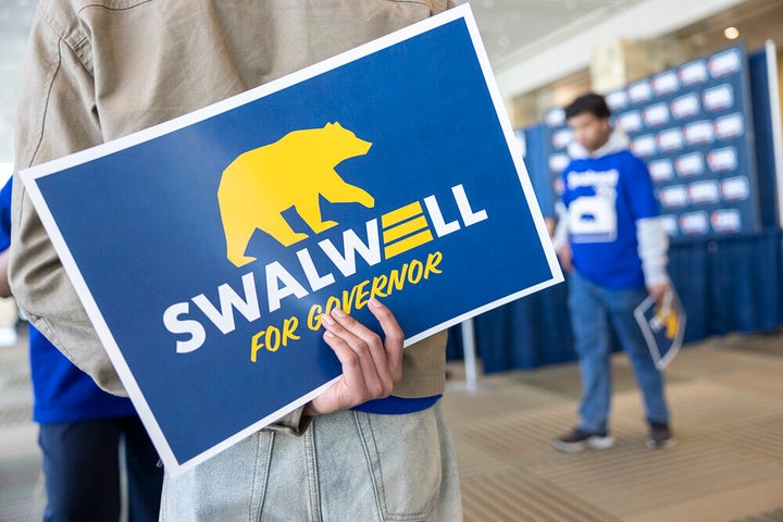 A Swalwell supporter holds a campaign sign at the California Democratic Party State Convention in February.