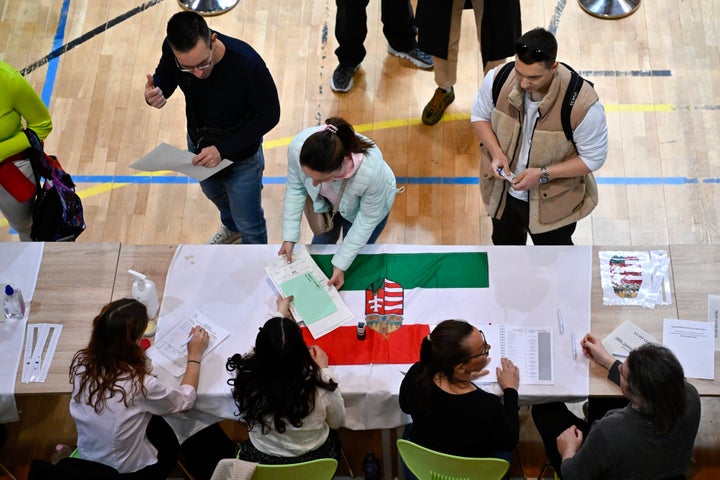 A woman votes at a polling station during the Hungarian parliamentary elections on Sunday, April 12, 2026 in Budapest, Hungary. (AP Photo/Denes Erdos)