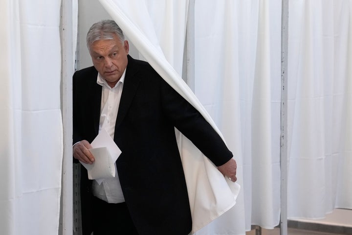 Hungarian Prime Minister Viktor Orban prepares to vote at a polling station in Budapest, Hungary, on Sunday, April 12, 2026. (AP Photo/Petr David Josek)