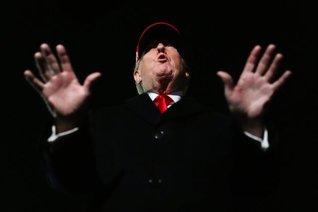 President Donald Trump speaks with reporters after disembarking Air Force One on Sunday.