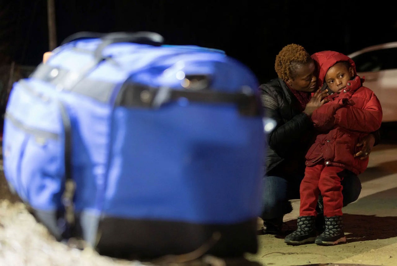 A woman comforts a child in 2023 as they make the journey to cross the border into Quebec from New York, shortly before the Safe Third Country Agreement changes were put in place.