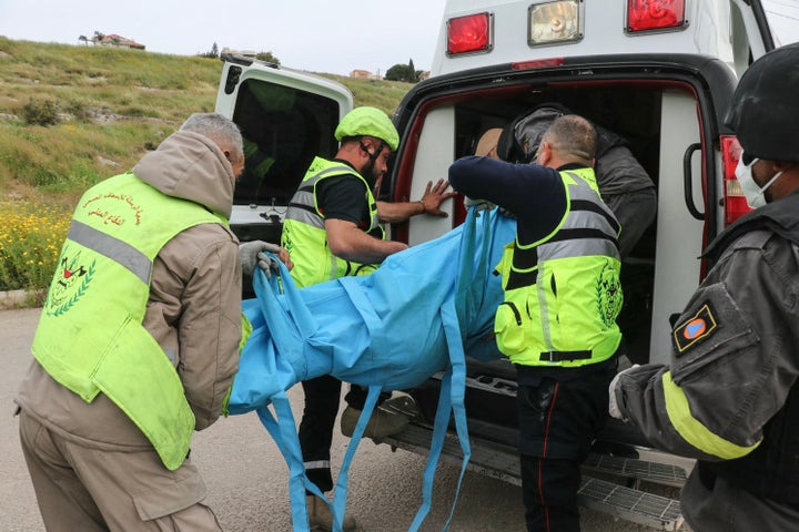First responders carry a body into an ambulance at the site of an Israeli airstrike in the southern Lebanese village of Abbasiyeh, on the outskirts of Tyre, on Wednesday.