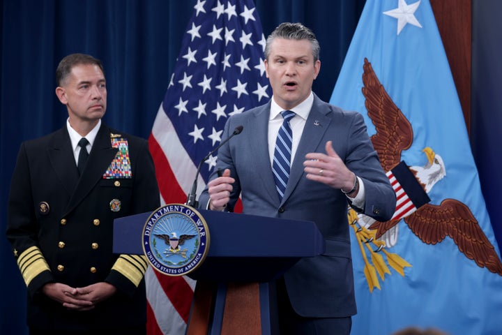 Secretary of War Pete Hegseth speaks as Adm. Brad Cooper, the leader of U.S. Central Command, listens during a press briefing at the Pentagon on Thursday.