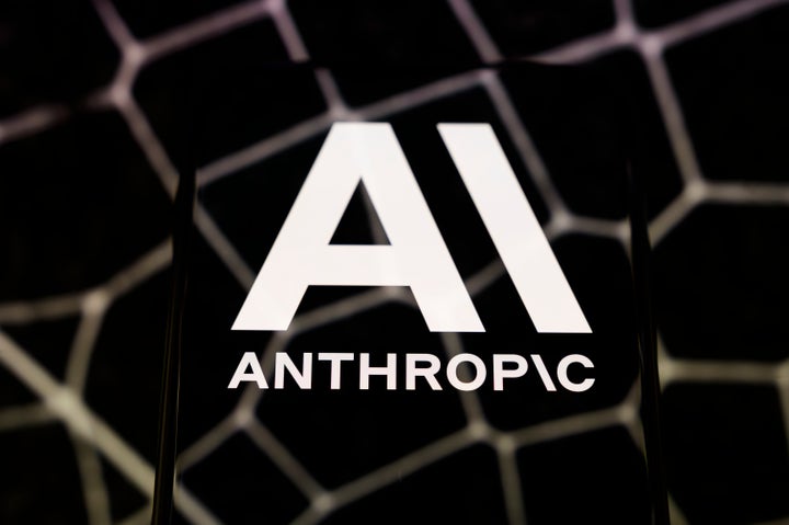 The Anthropic logo is displayed on a smartphone screen placed on a reflective surface onto which hexagonal patterns are projected, in Creteil, France, on April 8, 2026. (Photo by Samuel Boivin/NurPhoto via Getty Images)