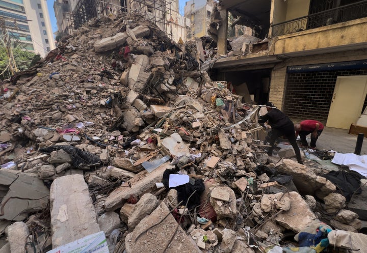 Workers search amongst the rubble of a destroyed building that was hit a week ago in an Israeli airstrike in central Beirut, Lebanon, Thursday, April 16, 2026. (AP Photo/Hussein Malla)