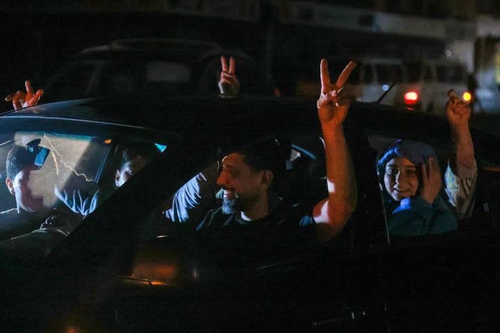 Supporters of Hezbollah celebrate the ceasefire with Israel as it takes effect, in the southern suburbs of Beirut, Lebanon, on April 17, 2026. Gunfire erupted in Beirut's southern suburbs as a ceasefire with Israel came into effect at midnight on April 17 (2100 GMT Thursday), according to AFP journalists and AFPTV footage. State media also reported "heavy gunfire" accompanying the start of the 10-day truce, announced earlier by US President Donald Trump. (Photo by ibrahim AMRO / AFP via Getty Images) /