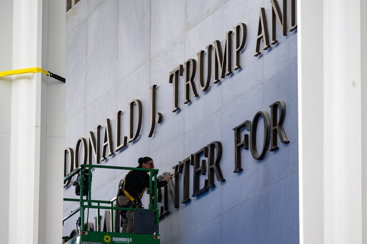 A worker adds President Donald J. Trump's name to the John F. Kennedy Memorial Center for the Performing Arts on December 19, 2025 in Washington, D.C. (Photo by Marvin Joseph/The Washington Post via Getty Images)
