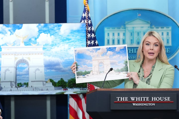 White House press secretary Karoline Leavitt holds up an artist rendering of the new triumphal arch as she speaks with reporters in the James Brady Press Briefing Room at the White House, Wednesday, April 15, 2026, in Washington.