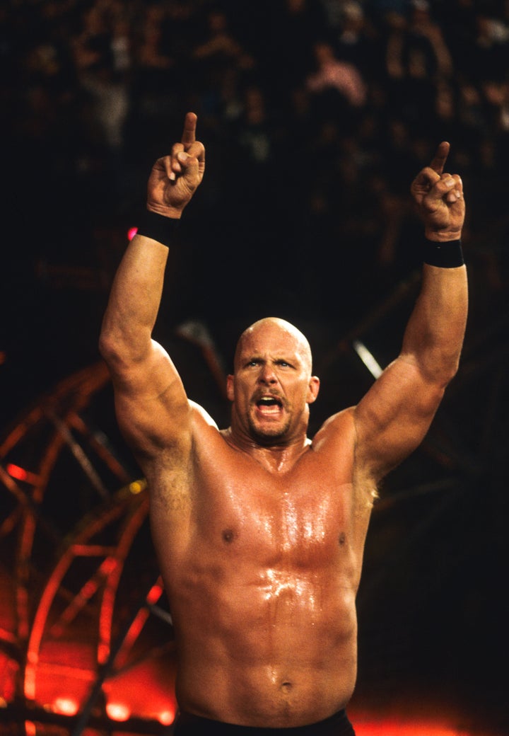 WWE star "Stone Cold" Steve Austin performing his signature "double gun salute" during a clash in 1999.