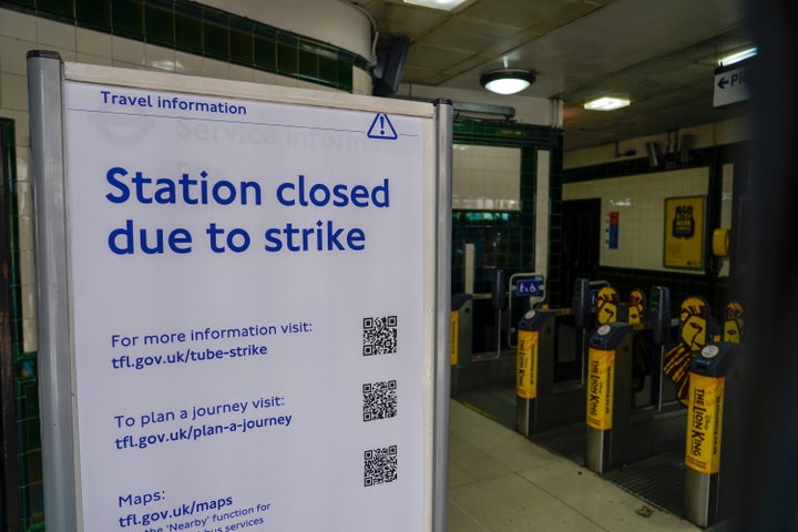 A sign reading 'Station closed due to strike' is placed inside Covent Garden Underground station, in London, Tuesday, June 21, 2022. Tens of thousands of railway workers walked off the job in Britain on Tuesday, bringing the train network to a crawl in the country's biggest transit strike for three decades. (AP Photo/Alberto Pezzali)