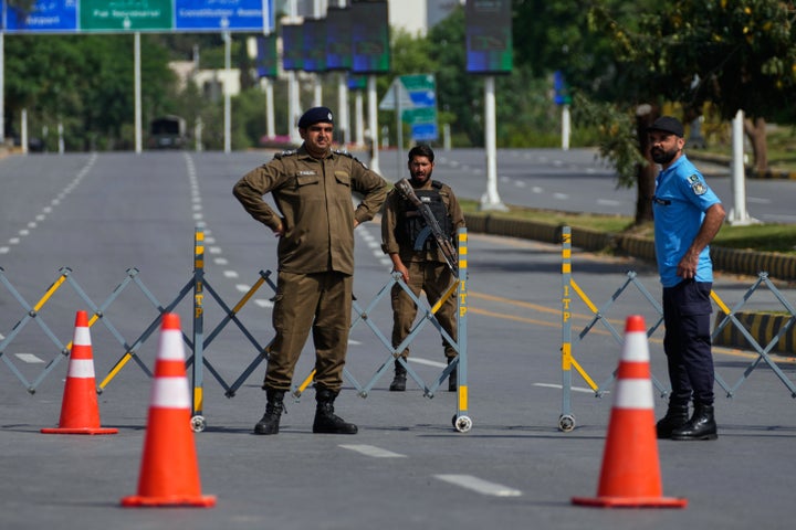 Police officers stand guard at a checkpoint on a barricaded ahead of the second round of negotiations between the U.S. and Iran, in Islamabad, Pakistan, on April 21, 2026. Security has been tightened across Pakistan’s capital, where authorities have deployed thousands of personnel and increased patrols along routes leading to the airport.