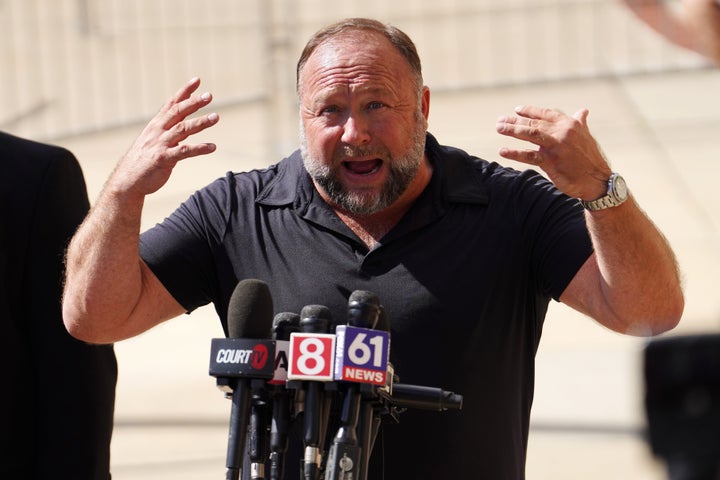 InfoWars founder Alex Jones speaks to the media outside Waterbury Superior Court during his trial in 2022 in Connecticut. Jones was sued by several families for causing emotional and psychological harm after they lost their children in the Sandy Hook massacre. Jones lost the case.