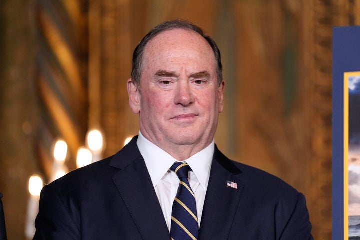 FILE - Secretary of the Navy John Phelan listens as President Donald Trump speaks at his Mar-a-Lago club, Dec. 22, 2025, in Palm Beach, Fla. (AP Photo/Alex Brandon, file)