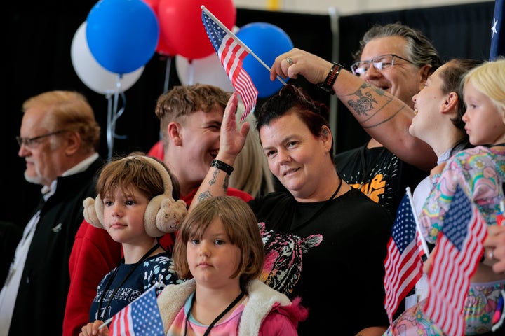 DULLES, VIRGINIA - MAY 12: Newly arrived South Africans wait to hear welcome statements from U.S. government officials in a hangar at Atlantic Aviation Dulles near Washington Dulles International Airport on May 12, 2025 in Dulles, Virginia.