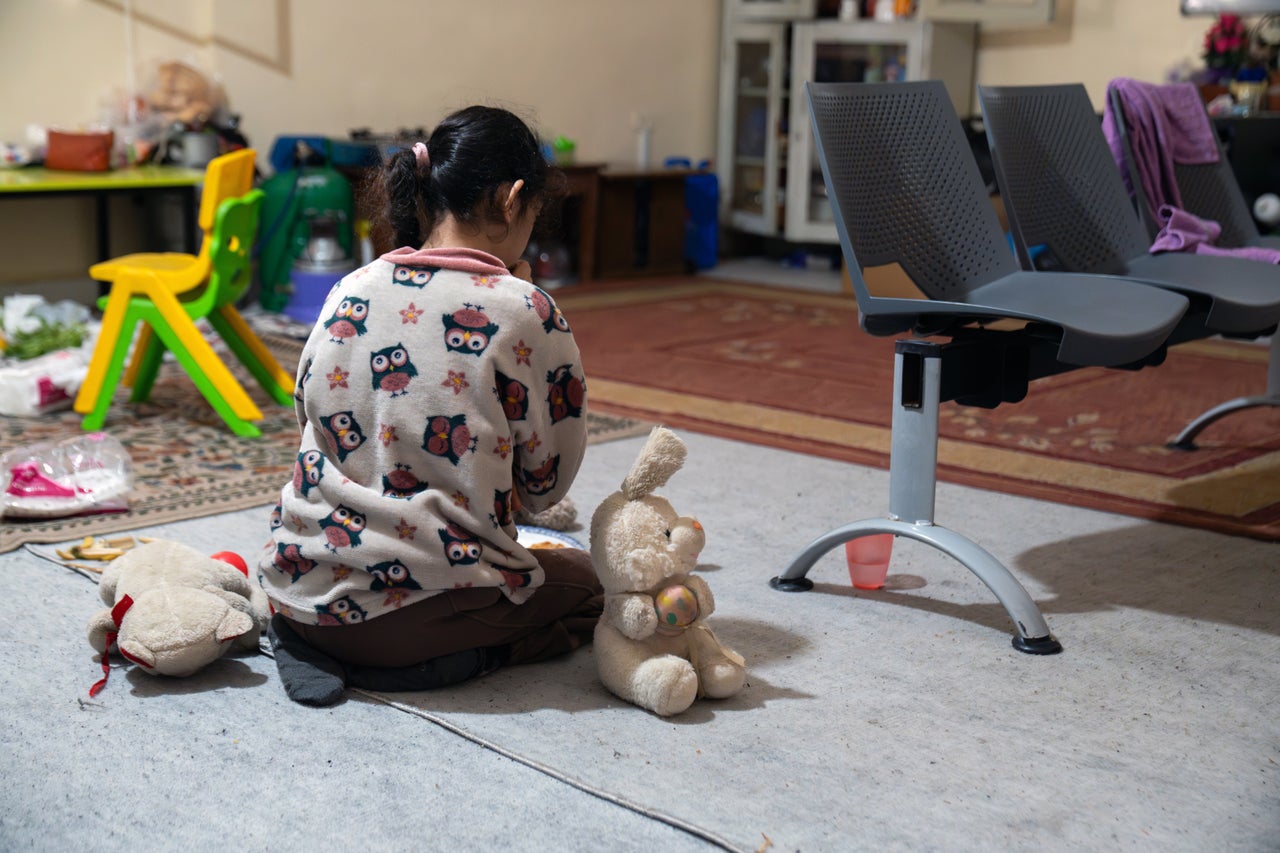 A girl sits with her toys at a Magdouche school-turned-shelter housing hundreds of families in South Lebanon on April 6, 2026. Children have been the hardest hit in Israel's military operations in Lebanon.