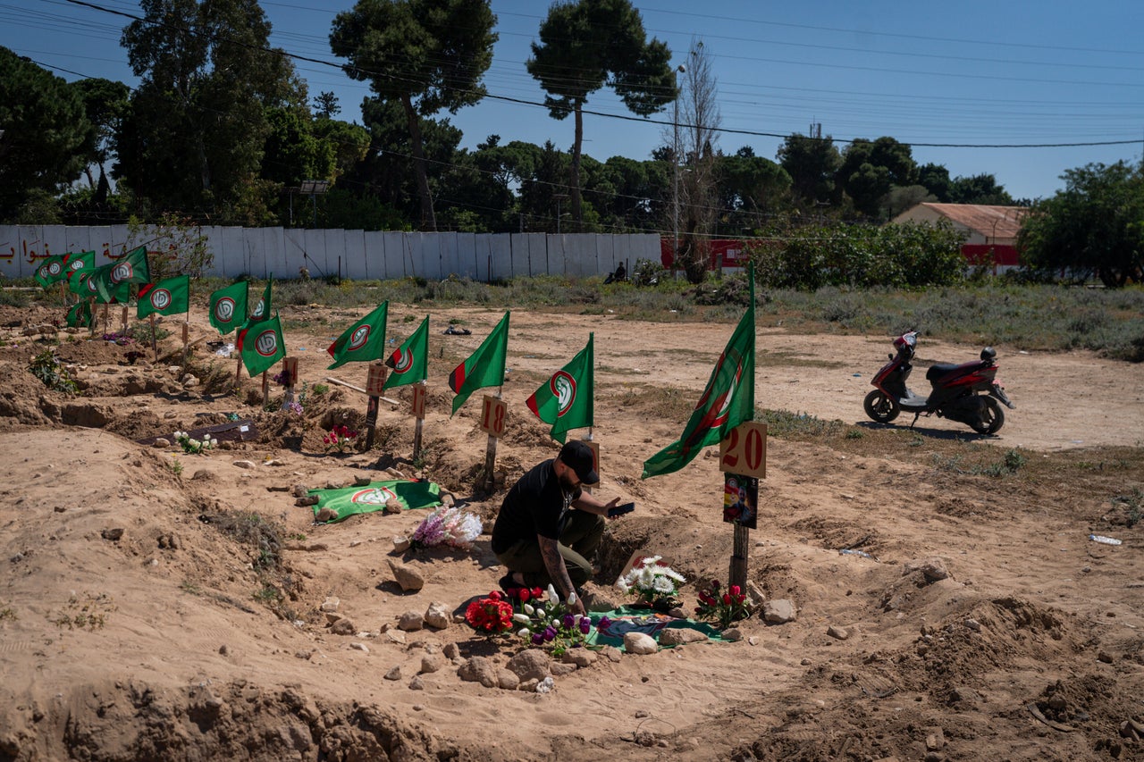 A man mourns a loved one buried at a temporary cemetery in Tyre, Lebanon, on April 23, 2026. Israel has killed more than 2,000 people in Lebanon since Hezbollah fired rocks into the country on March 2.