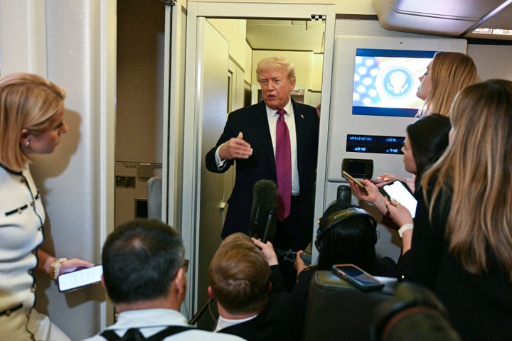 Trump speaks to the press aboard Air Force One in April.