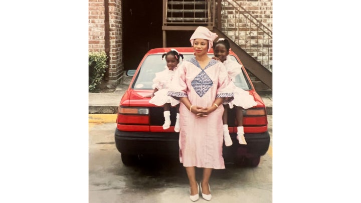 The author, her mom and her little sister posing in front of their apartment building in the early '90s.
