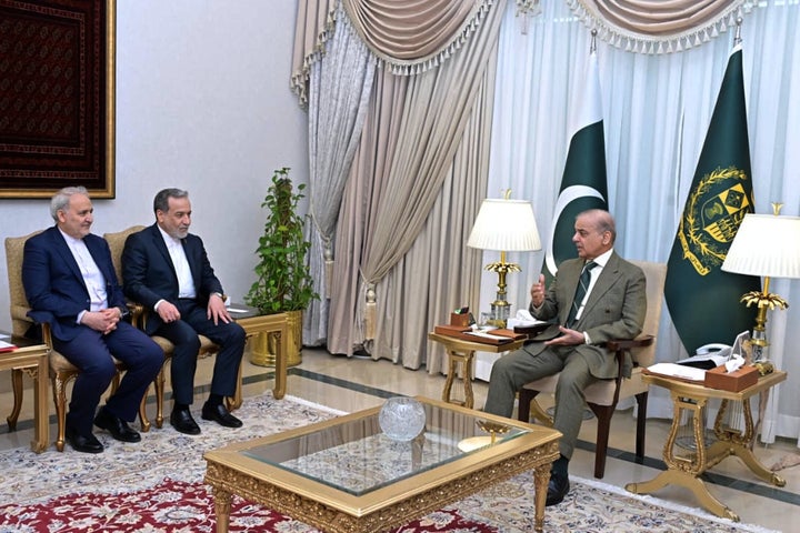 In this photo released by the Pakistan Prime Minister Office, Iran's Foreign Minister Abbas Araghchi, second left, meets with Prime Minister Shehbaz Sharif, in Islamabad, Pakistan, Saturday, April 25, 2026. (Pakistan Prime Minister Office via AP)