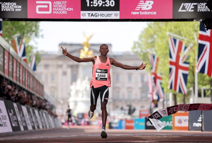 LONDON, ENGLAND - APRIL 26: Sabastian Sawe of Team Kenya celebrates crossing the line and winning with a new World Record time of 1:59:30 during the 2026 TCS London Marathon at on April 26, 2026 in London, England. (Photo by Alex Davidson/Getty Images)