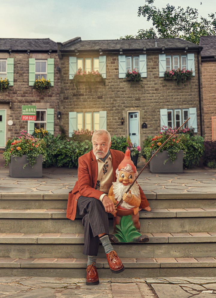 Graham Norton cosies up to a gnome on the set of his new series The Neighbourhood