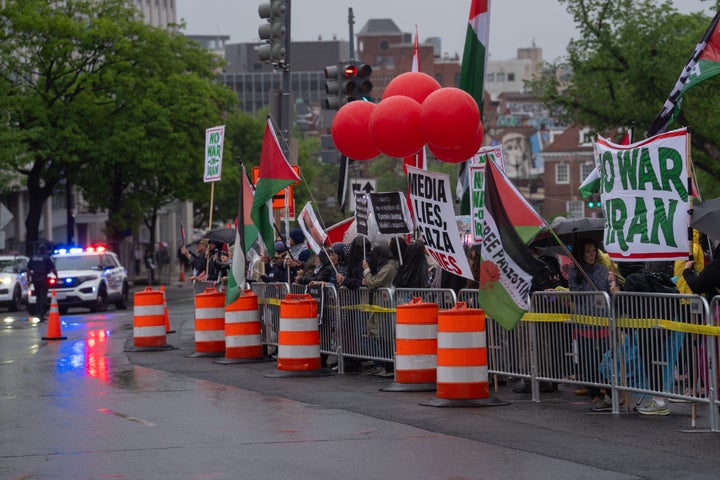 Protesters gather across the street from the Washington Hilton to demonstrate against the White House Correspondents' Dinner on Saturday.