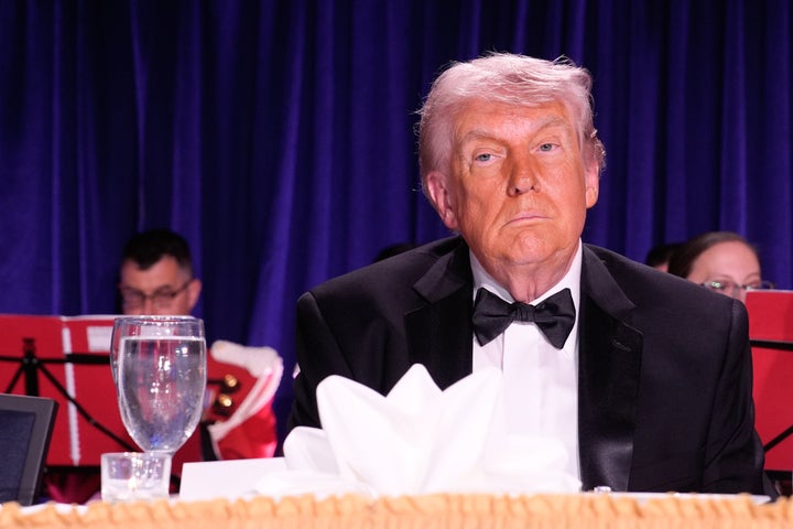 President Donald Trump sits onstage during the White House Correspondents' Association dinner in Washington, D.C., on Saturday before it was evacuated.