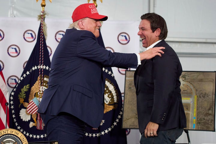 President Donald Trump talks with Florida Gov. Ron DeSantis (R) during a roundtable at "Alligator Alcatraz," a migrant detention facility at Dade-Collier Training and Transition facility, on July 1, 2025, in Ochopee, Florida. 