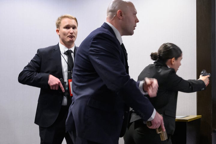 Agents draw their guns after loud bangs were heard during the White House Correspondents' Dinner at the Washington Hilton in Washington, D.C., on Saturday.