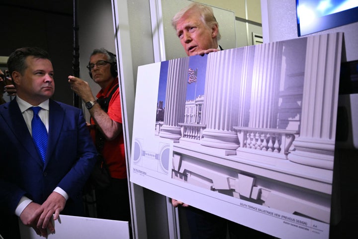 President Donald Trump holds a rendering of the planned White House ballroom on March 29.