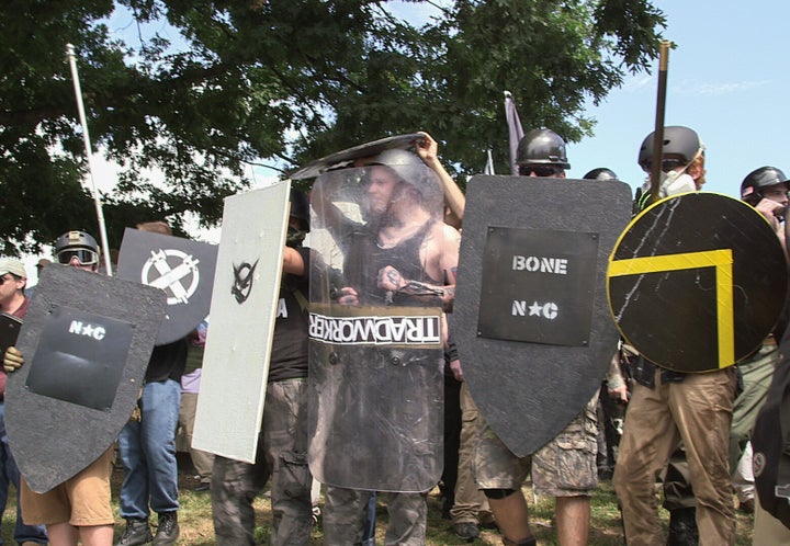 Right-wing extremist demonstrators hold shields during the Unite the Right free speech rally at Emancipation Park in Charlottesville, Virginia, on Aug. 12, 2017.